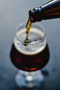 pouring stout beer in glass